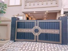 a large blue gate in front of a building