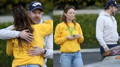 the man and woman are hugging each other in front of their car while they both wear yellow sweatshirts