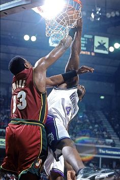 two basketball players in the air during a game