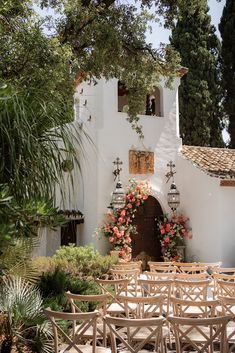 an outdoor wedding venue set up with wooden chairs