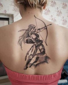 a woman with a tattoo on her back holding a bow and arrow in one hand