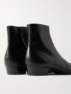 SAINT LAURENT's 'Augustin' boots are designed on an elongated last, creating tapered, chiselled toes that complement the label's iconic slim suiting. They've been crafted in Italy from black leather and have practical side zips for easy on and off. Formal Chelsea Boots With Snip Toe, Formal Fitted Chelsea Boots With Snip Toe, Formal Snip Toe Fitted Chelsea Boots, Fitted Snip Toe Chelsea Boots For Formal Occasions, Formal Fitted Chelsea Boots With Square Toe, Fitted Formal Chelsea Boots With Square Toe, Classic Chelsea Boots With Sculpted Heel For Formal Occasions, Luxury Fitted Calf Leather Chelsea Boots, Fitted Calf Leather Boots For Business