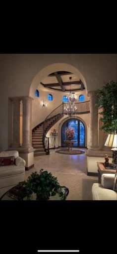 a living room filled with furniture and a staircase