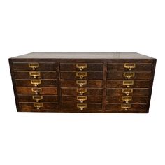 an old wooden dresser with many drawers and brass pulls on the front, against a white background