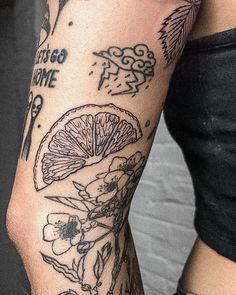 a woman's arm with tattoos on it that has fruit and flowers all over it