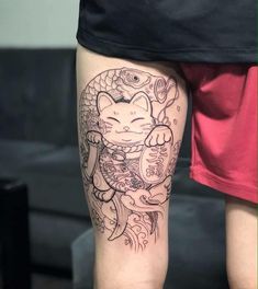 a person with a cat tattoo on their leg