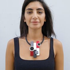 A unique statement necklace for women made from plexiglass, resin and acrylic colors and black crystals. This red necklace is lightweight and will upgrade any elegant outfit. Share with the world your exquisite taste! *   *   *   *   *   *   *   *   *   *   * Materials: 0.12/3mm thick plexiglass 0.12"/3mm thick acrylic mirror 0.31"/8mm thick black silicone cord Resin Black crystals Gold plated elements - 1.5 micron shiny finish Measurements: Central element width: 2.35"/6 cm Central element height: 4.35"/11 cm Maximum tickness: 0.6"/1.5 cm *   *   *   *   *   *   *   *   *   *   * For more jewelry from this collection click on the liink: https://www.etsy.com/shop/GilPashutDesigns?ref=seller-platform-mcnav§ion_id=32100580 *   *   *   *   *   *   *   *   *   *   * Care tips: I use only high Bold Black Jewelry For Gifts, Bold Black Jewelry For Gift, Bold Black Jewelry Gift, Bold Black Necklace For Gift, Bold Black Necklace For Gifts, Chic Red Necklace For Party, Modern Red Necklace For Party, Unique Statement Necklace, Red Necklace