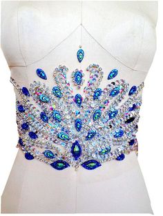 a close up of a dress on a mannequin with blue and white beads