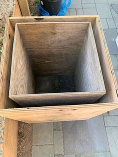 an empty wooden box sitting on the ground