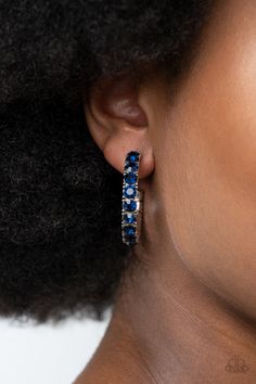 An oversized collection of glittery blue rhinestones are encrusted along a textured silver hoop, creating a glamorous sparkle. Earring attaches to a standard post fitting. Hoop measures approximately 1 1/2" in diameter. Sold as one pair of hoop earrings. Bedazzled Jewelry, Pink Friday, Earrings Trendy, Paparazzi Accessories, Blue Necklace, Paparazzi Jewelry, Blue Rhinestones, Blue Earrings, Silver Hoops