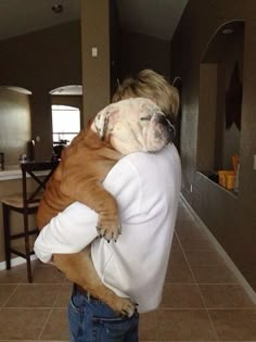 a person holding a dog in their arms