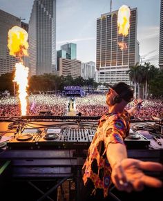 a dj performing in front of a large crowd