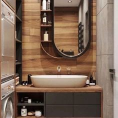 a bathroom with a sink, mirror and washer dryer in it's corner