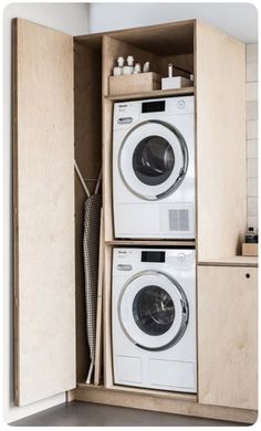 a washer and dryer in a wooden cabinet