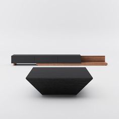 a black and wooden table sitting on top of a white floor