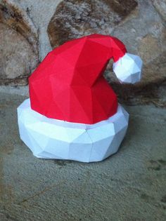 an origami santa hat sitting on the ground