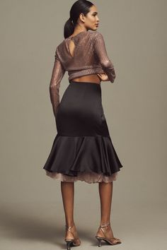 a woman in a black skirt and top