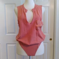 Nwot. The Tags Have Been Removed But This Bodysuit Has Never Been Worn. Perfect With A Pair Of Cutoff Jeans And Sandals. Sleeveless. Deep V-Neckline. One Pocket On The Left Side. Body Is Made Of 100% Cotton, Bottom Is Made Of 95% Cotton, 5% Spandex. Machine Washable. Thank You For Your Interest And I'm More Than Happy To Answer Any Questions And Consider All Reasonable Offers. Chic Sleeveless Bodysuit For Loungewear, Peach Fitted Sleeveless Tank Top, Fitted Peach Sleeveless Tank Top, Fitted Sleeveless Peach Tank Top, Pink Sleeveless Bodysuit For Loungewear, Sleeveless Bodysuit For Loungewear, Pink Sleeveless Bodysuit For Spring, Chic Sleeveless Cotton Bodysuit, Chic Sleeveless Pink Bodysuit