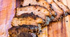 sliced pork on a wooden cutting board ready to be served for dinner or barbecue party