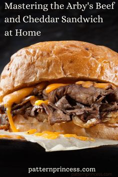 a roast beef sandwich with cheese and sauce