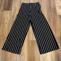 Long Stripped Pants With Tag Wide Legs 2 Pockets Size M Waist 30 Inches Hips 40 Inches Length 39 Inches Bottom Leg Wide 13 Inches Flat Si A Small: Waist 26 Inches, Hips 34 Inches Length 39 Inches Legs Bottom Wide 12 Inches Flat Stretch Wide Leg Bottoms With Vertical Stripes, Striped Stretch Wide Leg Bottoms, Trendy Black Bottoms With Vertical Stripes, Casual Black Bottoms With Vertical Stripes, Trendy Wide Leg Bottoms With Vertical Stripes, Black Wide-leg Pants With Vertical Stripes, Black Pants With Vertical Stripes For Summer, Black High-waisted Bottoms With Vertical Stripes, Black Trousers With Vertical Stripes