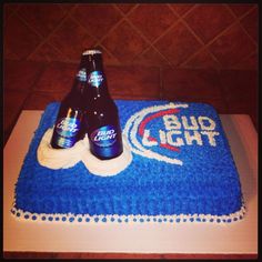 two beer bottles on top of a blue cake with the bud light logo on it