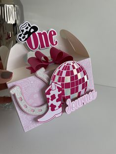 a pink and white card with the word one on it