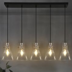 an image of a light fixture with five lights hanging from it's sides and four glass vases on each side