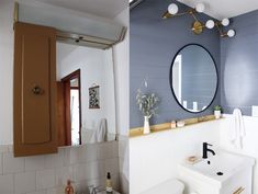 a bathroom with blue walls and white tile on the floor, along with a gold framed mirror