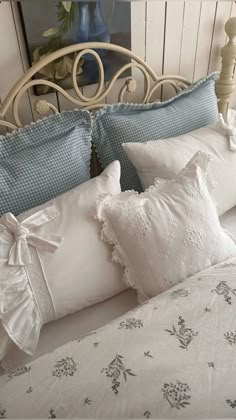 a white bed topped with lots of pillows