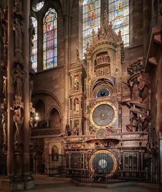 an ornate clock in the middle of a cathedral