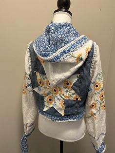 a denim jacket with sunflowers on it