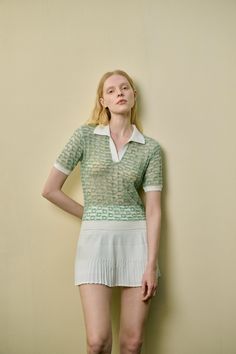 Lightweight knit Semi sheer Polo color Contrast trim Regular fit This light green, semi-sheer top features a classic polo collar, with white trim on the collar, cuffs, and hem for a fresh, stylish contrast. The breathable, lightweight fabric ensures comfort and ease, making it an ideal choice for pairing with a mini skirt. Embrace the sporty casual vibe with this versatile piece, perfect for any relaxed day out. Elegant Summer Tops With Ribbed Collar, Elegant Fitted Tops With Contrast Trim, Spring Pointelle Knit Top With Polo Collar, Chic Tops With Contrast Collar, Fitted Top With Contrast Collar For Spring, Summer Collared Tops With Contrast Trim, Collared Tops With Contrast Trim For Summer, Summer Collared Pointelle Knit Tops, Casual Summer Tops With Contrast Collar