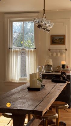 a wooden table sitting in front of a window