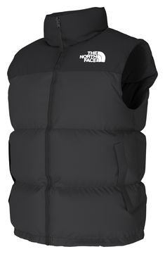 A retro North Face vest based on a baffle-quilted, down-insulated design from 1996 offers unmatched warmth right at the core. The durable ripstop shell with double-layer taffeta at the shoulders is perfect for backpacking, thanks to its packable design that can be stowed in its own pocket. 26 1/2" length (size Medium) Front two-way zip closure Stowaway hood Sleeveless Front zip pockets; interior zip pocket Lined with 700-fill power goose down 40D 54 g/m² 100% nylon ripstop with durable water-rep The North Face Nuptse 1996, North Face Nuptse, North Face Vest, Down Vest, Backpacking, Double Layer, North Face, Zip Pockets, The North Face