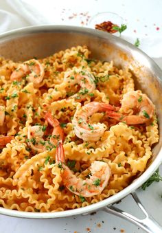 pasta with shrimp and parsley in a skillet