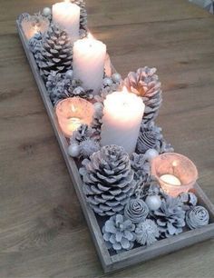 a table with candles and pine cones on it