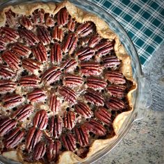 a pie with pecans in it on a table