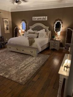 a bedroom with a bed, dressers and mirror on the wall next to it