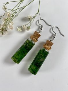 Real moss encased in a dainty resin bottle. These earrings are shatter proof and made of resin instead of glass.  1 pair of earrings.  Dimensions-  Height: 35mm (1.38inch) Diameter: 11mm (0.43 inch). Green Pressed Flowers Earrings For Gift, Green Earrings With Pressed Flowers For Gift, Moss Jar, Moss Earrings, Silly Earrings, Resin Bottle, Earrings Cottagecore, Ren Faire Outfits, Cottagecore Earrings