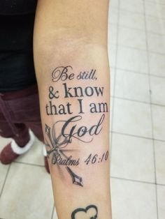 a person with a tattoo on their arm saying, be still and know that i am god