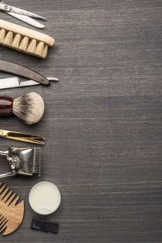 several different types of hairbrushes and combs on a wooden table with other items