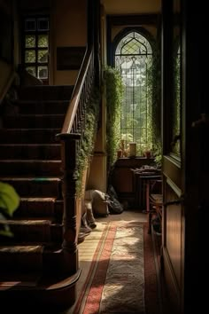 a dog laying on the floor in front of a set of stairs with an arched window