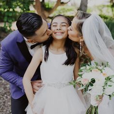 a bride and groom kissing each other on their wedding day