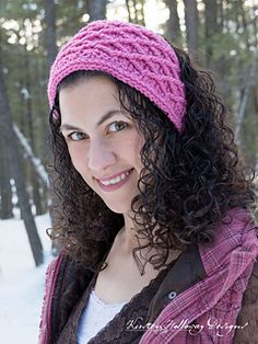 a woman wearing a pink knitted headband in the snow