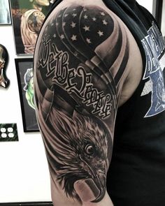 a man with an eagle and american flag tattoo on his arm