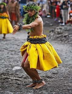 a man dressed as a hula dancer in the middle of a festival with other people watching