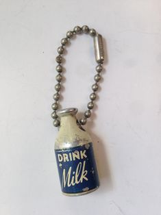 a metal bottle with a chain attached to it