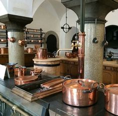 copper pots and pans are sitting on the counter