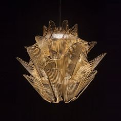 a large chandelier hanging from the ceiling in a dark room with black background